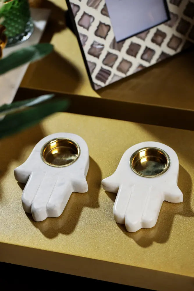 Parami marble tealight holder in palm shape featuring a brass tealight cup
