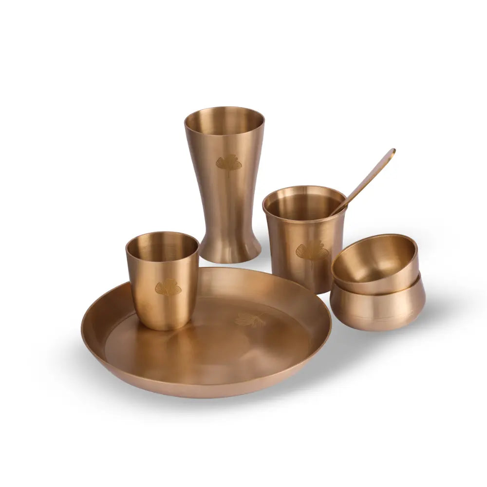 Kansa Utensils Kansa Tall Glass showcased with matching handcrafted kansa diningware by Parami