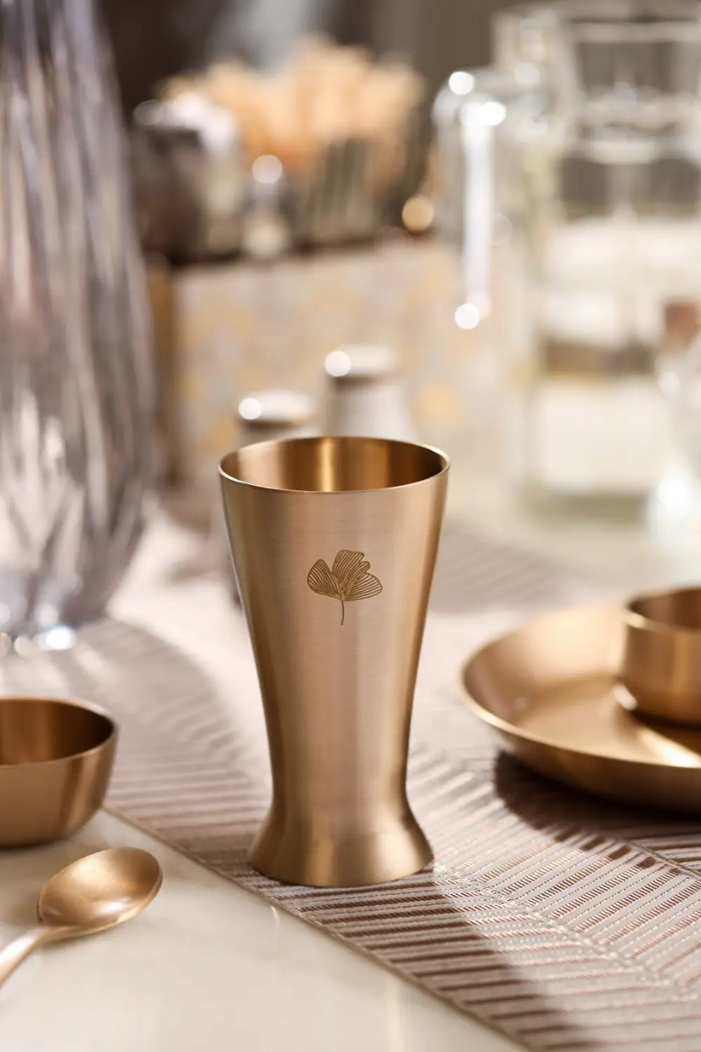 Kansa Utensils Kansa Tall Glass displayed in an elegant dining table setting by Parami