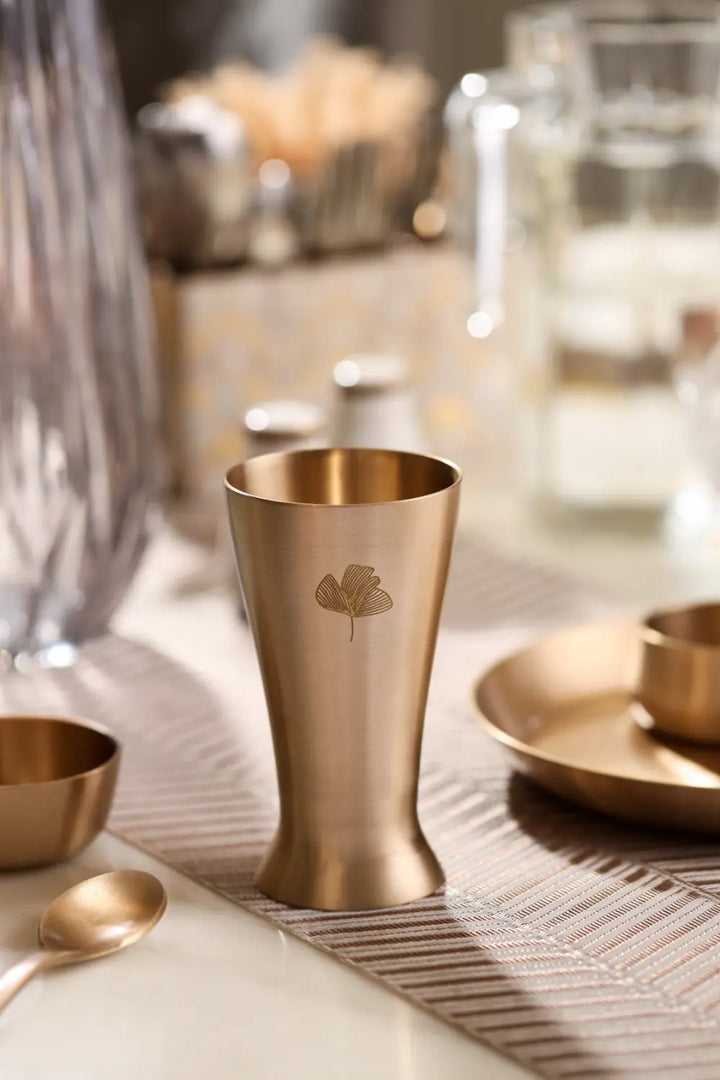 Kansa Utensils Kansa Tall Glass displayed in an elegant dining table setting by Parami