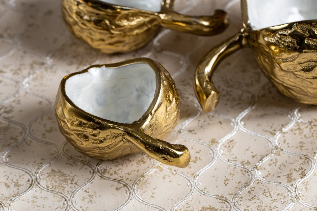 Gold serving bowl set with elegant shell handle design by Parami